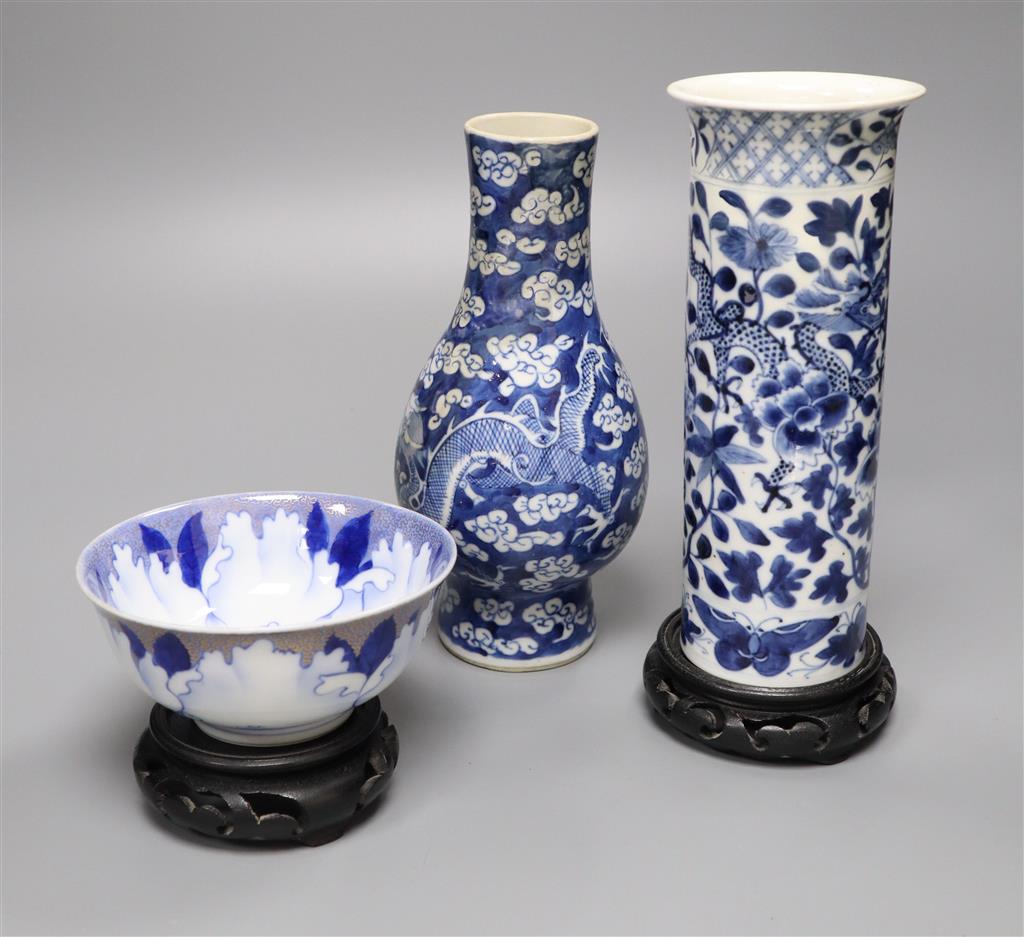 A Chinese blue and white vase with four-character mark, a similar cylindrical vase and a small bowl, tallest 21cm